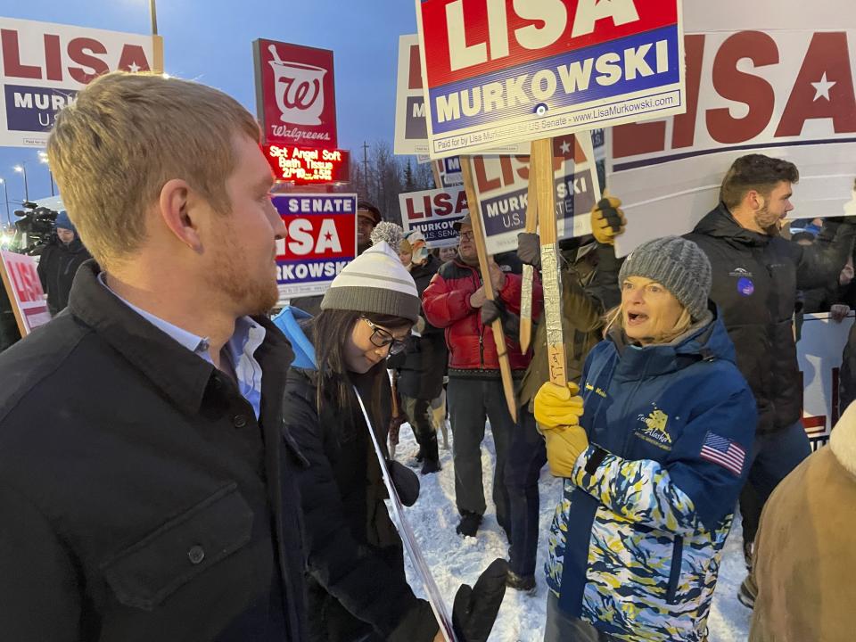 U.S. Sen. Lisa Murkowski, a Republican seeking reelection in Alaska, is shown talking with her nephew, Luke Murkowski, who flew in from Nome, Alaska, to surprise her at a sign-waving event on a busy Anchorage, Alaska, corner on Election Day, Tuesday, Nov. 8, 2022. (AP Photo/Mark Thiessen)