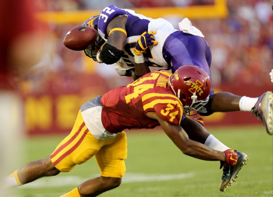 Northern Iowa running back Tyvis Smith loses the ball as he is hit by Iowa State defensive back Nigel Tribune during the first half of an NCAA college football game, Saturday, Sept. 5, 2015, in Ames, Iowa. (AP Photo/Justin Hayworth)