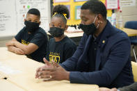 EPA Administrator Michael Regan, discuss with Wilkins Elementary School fourth grade students, Javaris Webster, left, and Brookelynn Knight, how the city's water problems affects many of the city's schools, Monday, Nov. 15, 2021, in Jackson, Miss. On Tuesday, Nov. 16, several schools resorted to virtual learning as the city reported low or no water pressure throughout the city and schools affected were closed for the day. Regan and others toured the school, as part of the agency's "Journey to Justice" tour through Mississippi, Louisiana and Texas, spotlighting longstanding environmental concerns in historically marginalized communities. (AP Photo/Rogelio V. Solis)