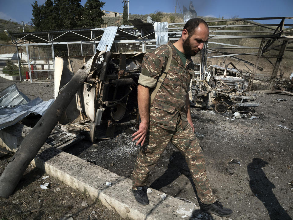 Gevorg, a doctor of a local hospital damaged by shelling from Azerbaijan's artillery, walks in the yard of his hospital in the town of Martakert, during a military conflict, in the separatist region of Nagorno-Karabakh, Thursday, Oct. 15, 2020. The conflict between Armenia and Azerbaijan is escalating, with both sides exchanging accusations and claims of attacks over the separatist territory of Nagorno-Karabakh.(AP Photo)