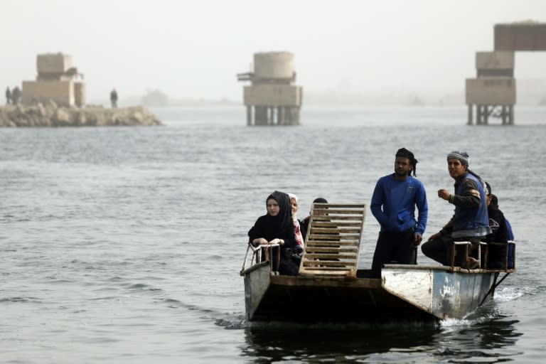 Syrians cross the Euphrates River from the city of Raqa to villages south of the city on ferries on October 15, 2018