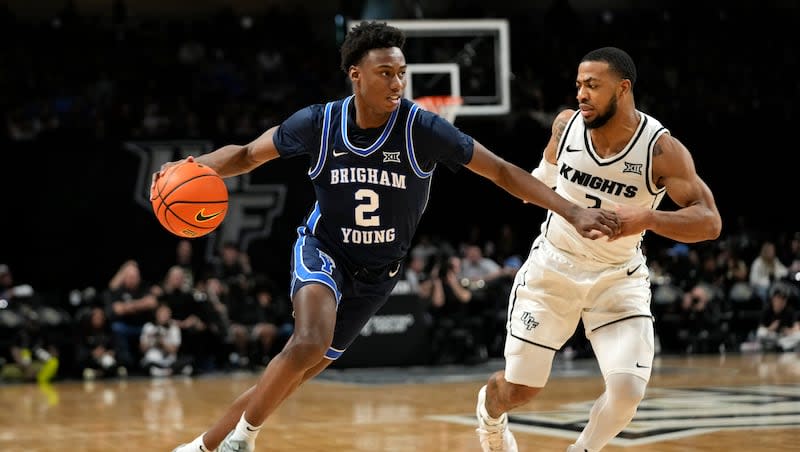 BYU guard Jaxson Robinson (2) drives past Central Florida guard Darius Johnson, right, during the second half of an NCAA college basketball game, Saturday, Jan. 13, 2024, in Orlando, Fla.  The Cougars and the Knights will play Wednesday morning in the second round of the 2024 Big 12 Tournament. BYU is the No. 5 seed, UCF the No. 12 seed.