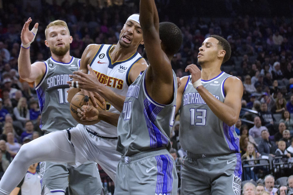 Denver Nuggets forward Zeke Nnaji is guarded by Sacramento Kings forward Domantas Sabonis,left, Harrison Barnes (40) and Sacramento Kings forward Keegan Murray (13) during the first quarter of an NBA basketball game in Sacramento, Calif., Wednesday, Dec. 28, 2022. (AP Photo/Randall Benton)