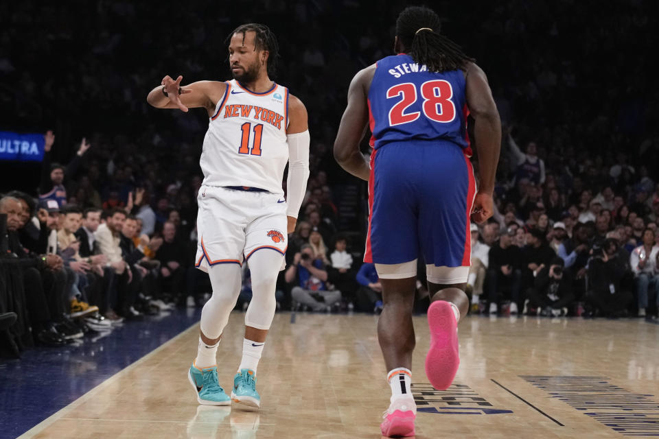 New York Knicks' Jalen Brunson (11), left, reacts after hitting a three-point shot while Detroit Pistons' Isaiah Stewart (28) looks on during the first half of an NBA basketball game, Thursday, Nov. 30, 2023, in New York. (AP Photo/Seth Wenig)