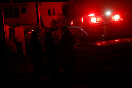 Paramedics wait outside a building after making an emergency service call in an area affected by Hurricane Maria in San Juan, Puerto Rico, October 13, 2017. REUTERS/Shannon Stapleton