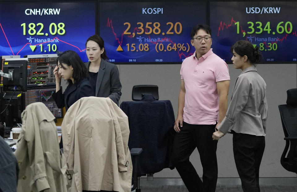 Currency traders work near the screens showing the Korea Composite Stock Price Index (KOSPI), center, and the foreign exchange rate between U.S. dollar and South Korean won, right, at the foreign exchange dealing room of the KEB Hana Bank headquarters in Seoul, South Korea, Friday, Nov. 3, 2023. (AP Photo/Ahn Young-joon)