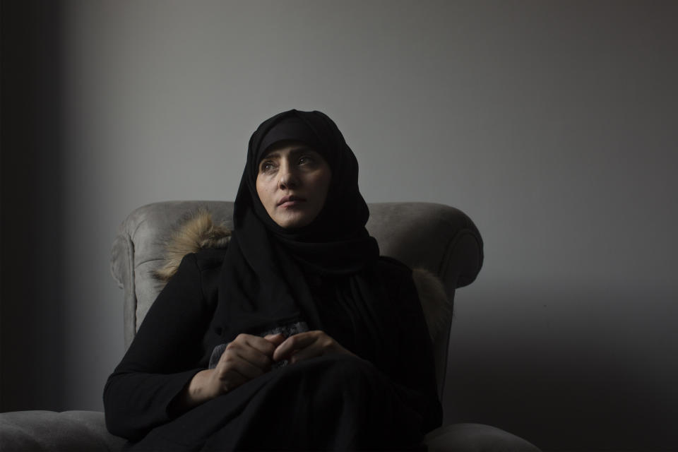 In this March 4, 2020 photo, Samera al-Huri, poses for a portrait in her home near Cairo, Egypt. As they grow more politically active, women are increasingly targeted by the Houthi rebels who rule northern Yemen. Hundreds of women have vanished into secret prisons where they are tortured and sometimes raped, former detainees and other activists say. The Houthis deny the claims, but six women who escaped to Egypt spoke to the Associated Press about their ordeals. (AP Photo/Maya Alleruzzo)