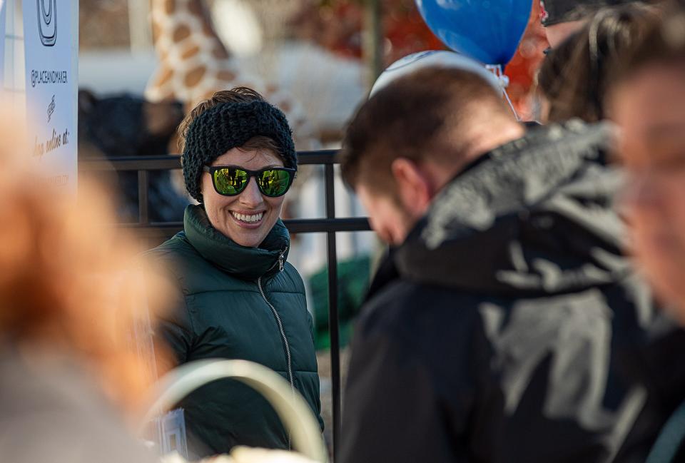 Artist Amy Talbott of Place and Maker Studio smiled as shoppers looked over her artwork at Colonial Gardens during Small Business Saturday LIVE 2021. Nov. 27, 2021