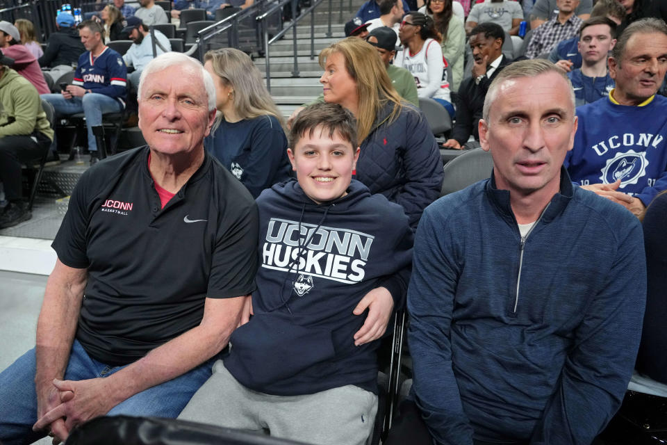 Bob Hurley Sr., left, Gabe Hurley, center, and Bobby Hurley attend the game between Arkansas and UConn at T-Mobile Arena.