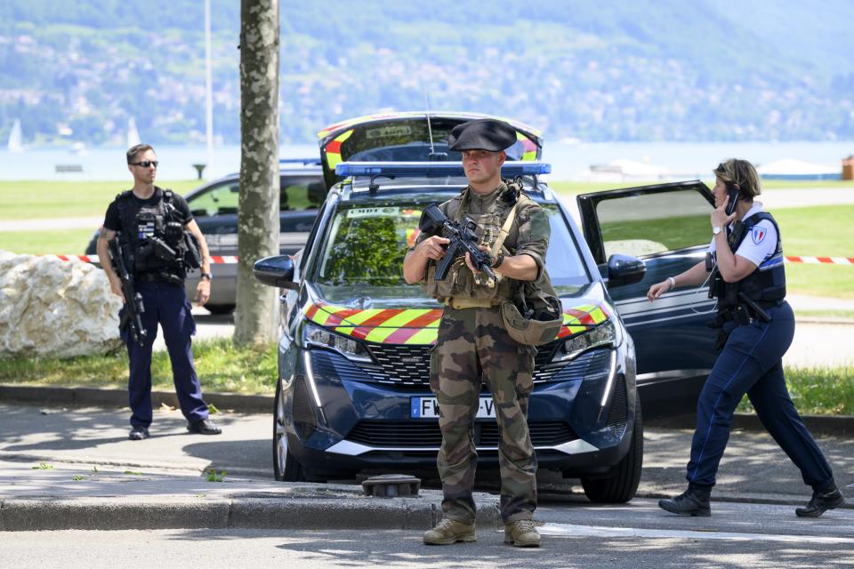 Police gather at a cordoned-off area (EPA)