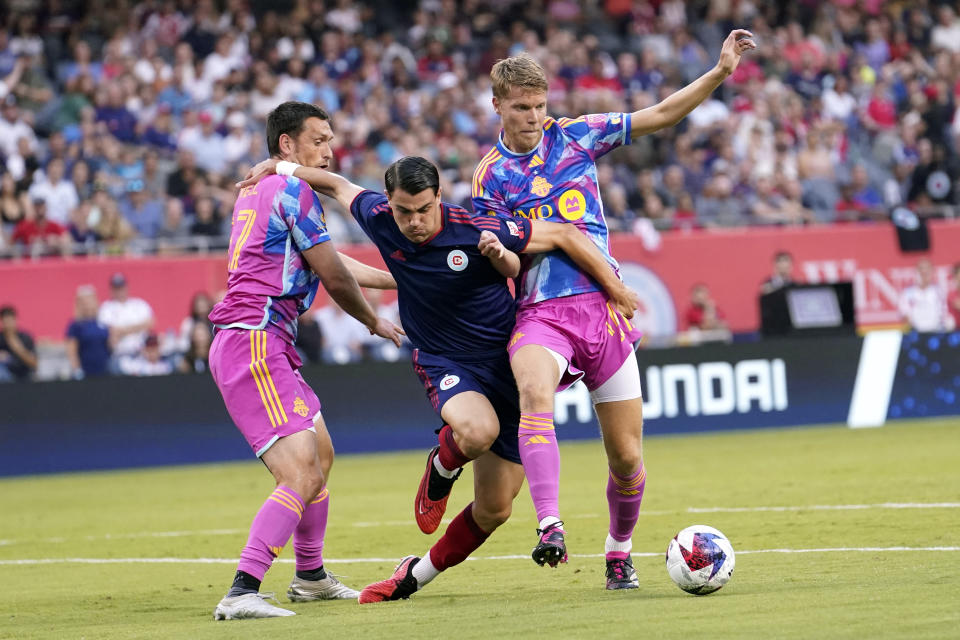 Toronto FC defenders Shane O'Neill, left, and Sigurd Rosted, right, cut off Chicago Fire forward Georgios Koutsias, center, from the ball during the first half of an MLS soccer match Saturday, July 15, 2023, in Chicago. (AP Photo/Charles Rex Arbogast)