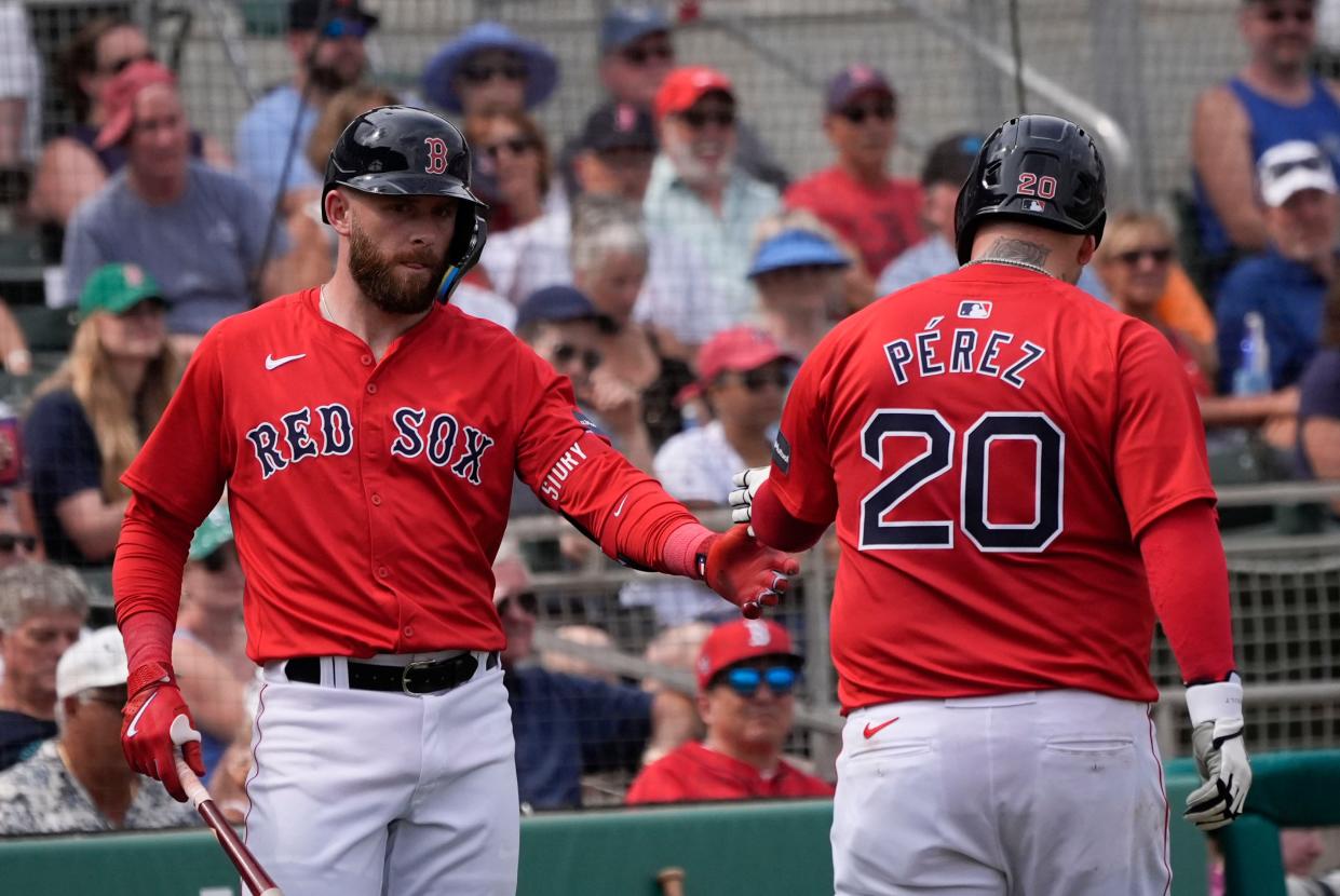 The Red Sox's Roberto Perez (20) is greeted by Trevor Story after scoring a run in the fourth inning of a spring-training  game against the Detroit Tigers in Fort Myers, Fla., on Thursday.