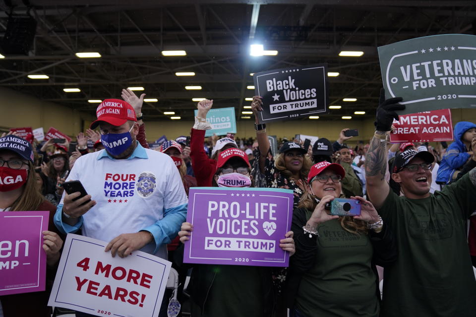 Supporters of President Donald Trump cheer as he arrives for a campaign rally at MBS International Airport, Thursday, Sept. 10, 2020, in Freeland, Mich. (AP Photo/Evan Vucci)