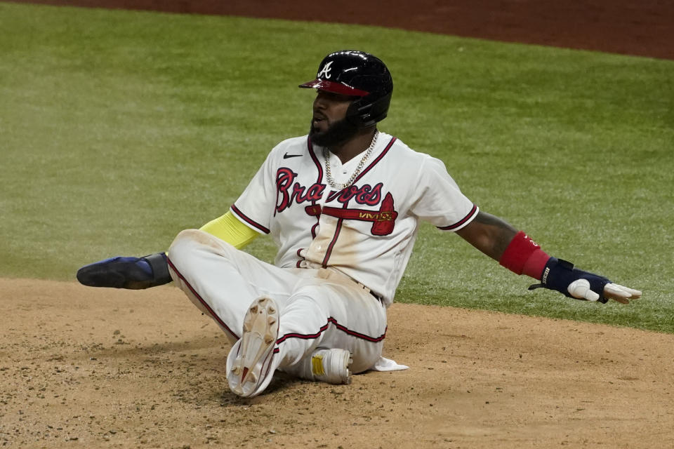 Atlanta Braves' Marcell Ozuna watches after getting called out at home after leaving third early during the third inning in Game 5 of a baseball National League Championship Series against the Los Angeles Dodgers Friday, Oct. 16, 2020, in Arlington, Texas. (AP Photo/Tony Gutierrez)