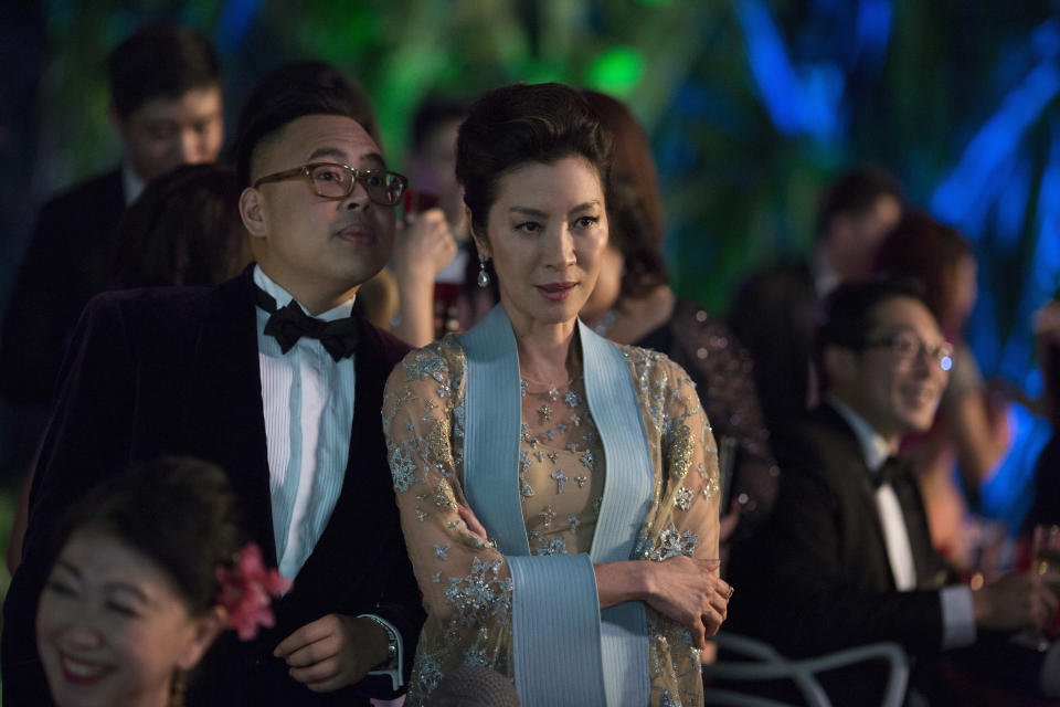 This image released by Warner Bros. Entertainment shows Nico Santos, left, and Michelle Yeoh in a scene from the film "Crazy Rich Asians." (Sanja Bucko/Warner Bros. Entertainment via AP)