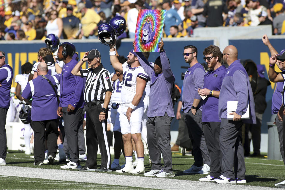 TCU players and staff celebrate during the first half of an NCAA college football game against West Virginia in Morgantown, W.Va., Saturday, Oct. 29, 2022. (AP Photo/Kathleen Batten)