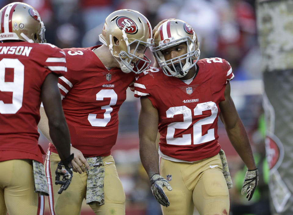 San Francisco 49ers running back Matt Breida (22) is congratulated by quarterback C.J. Beathard (3) after scoring a touchdown. (AP)