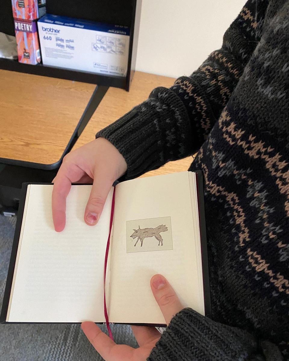 Zoe Gianfrancesco, a senior at the Lincoln Park Performing Arts Charter School, holds a finished copy of the new book by best-selling author Daniel Wallace. Lincoln Park's student press is publishing the book.