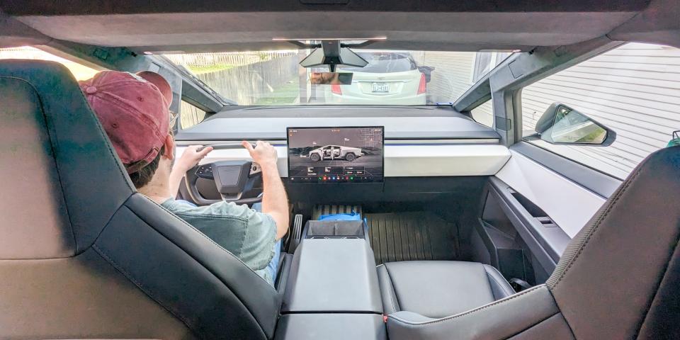 Tesla Cybertruck interior cockpit, with driver in seat