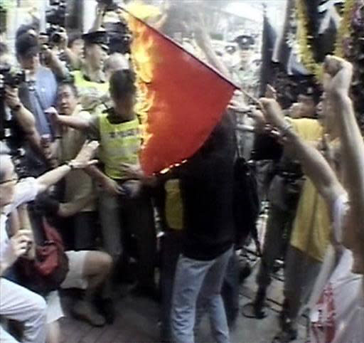 Demonstrators in Hong Kong burn the Chinese flag to protest against the proposed Article 23 legislation in July 2003.  (AP file)