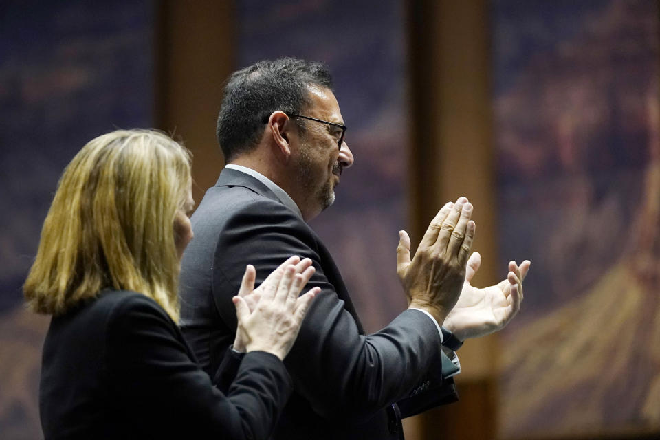 Arizona Democratic Secretary of State Adrian Fontes and Arizona Attorney General Kris Mayes, left, give a standing ovation as Arizona Democratic Gov. Katie Hobbs gives the state of the state address at the Arizona Capitol in Phoenix, Monday, Jan. 9, 2023. (AP Photo/Ross D. Franklin)