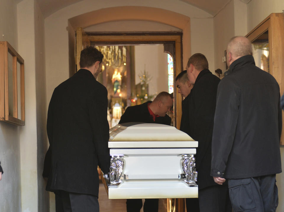 The coffin with the body of Lukasz Urban, the Polish truck driver killed in the Berlin Christmas market attack, is carried into the church in Banie, Poland, Friday, Dec. 30, 2016, ahead of the funeral ceremonies. (AP Photo/Lukasz Szelemej)