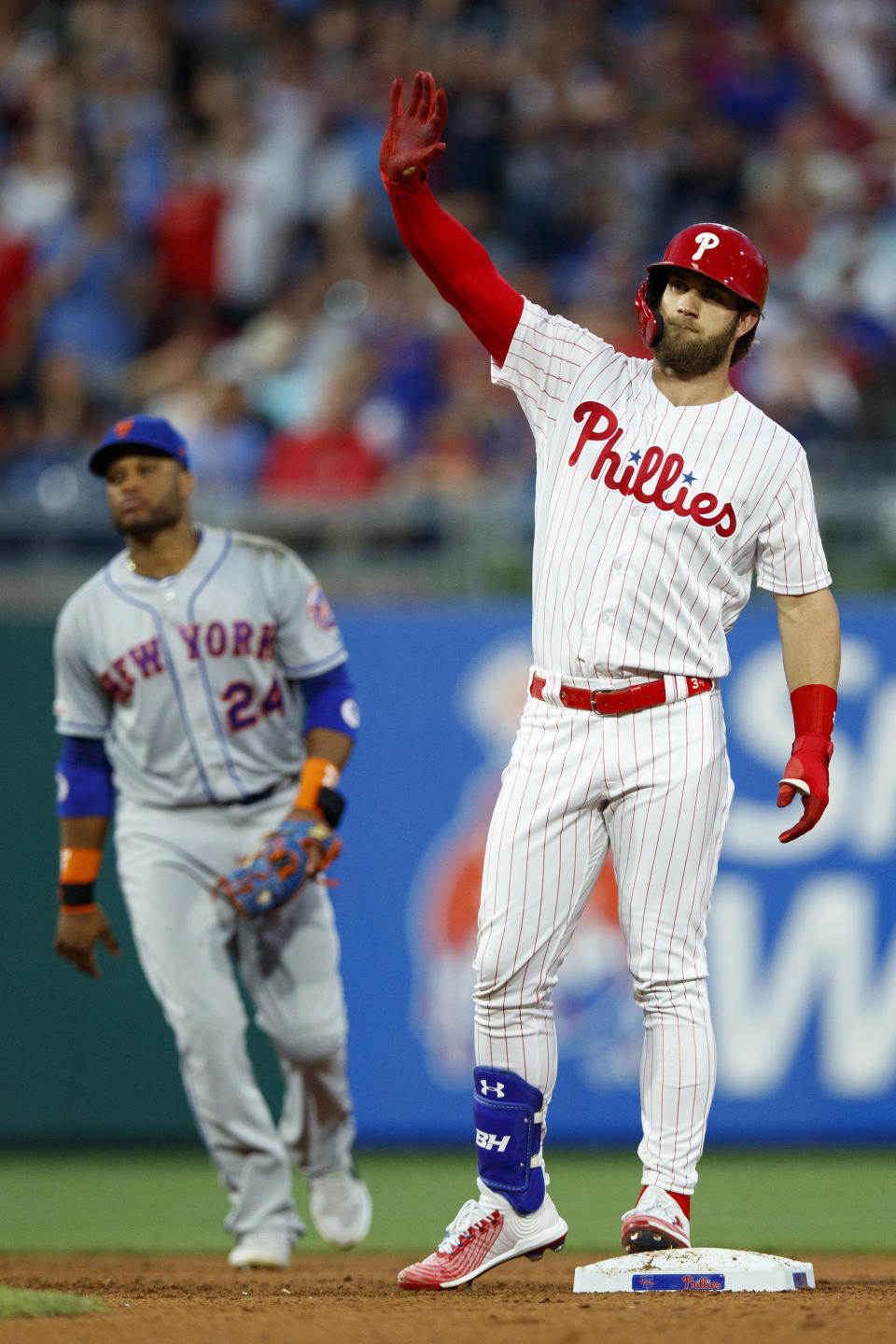 Philadelphia Phillies' Bryce Harper, right, celebrates near New York Mets' Robinson Cano after hitting an RBI-double during the fourth inning of a baseball game, Monday, June 24, 2019, in Philadelphia. (AP Photo/Matt Slocum)