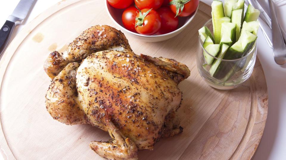 rotisserie chicken on a wooden cutting board