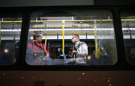 Broken windows on an official media bus after they shattered when driving accredited journalists to the Main Transport Mall from the Deodoro venue of the Rio 2016 Olympic Games. REUTERS/Adrees Latif