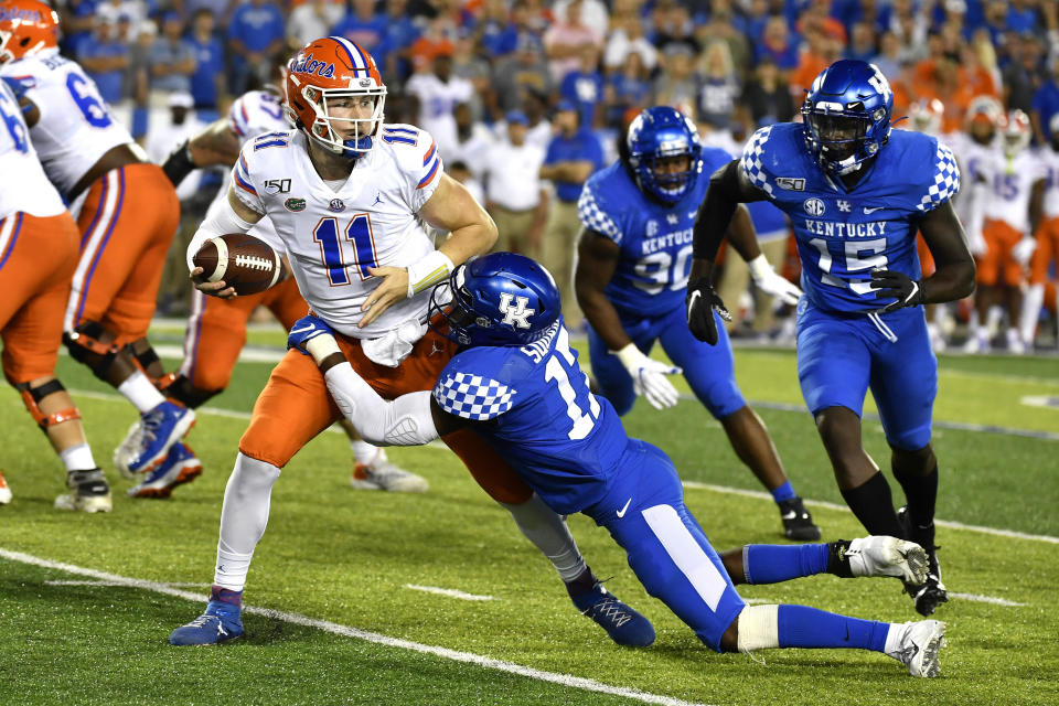 Kentucky linebacker DeAndre Square (17) tries to bring down Florida quarterback Kyle Trask (11) during the second half of an NCAA college football game in Lexington, Ky., Saturday, Sept. 14, 2019. (AP Photo/Timothy D. Easley)