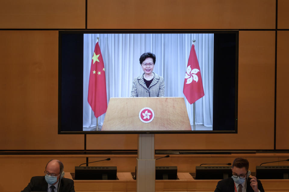 Hong Kong's chief executive Carrie Lam is seen on a giant screen remotely addressing the opening of the UN Human Rights Council's 44th session on June 30, 2020 in Geneva. - Hong Kong's chief executive defended China's sweeping national security law for the city before the United Nations, urging the international community to "respect our country's right to safeguard national security." (Photo by Fabrice COFFRINI / AFP) (Photo by FABRICE COFFRINI/AFP via Getty Images)