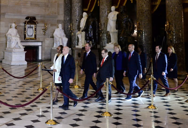 Secretary of the Senate Irving, House Clerk Johnson and impeachment managers walk through Statuary Hall with the articles of impeachment in the U.S. Capitol in Washington