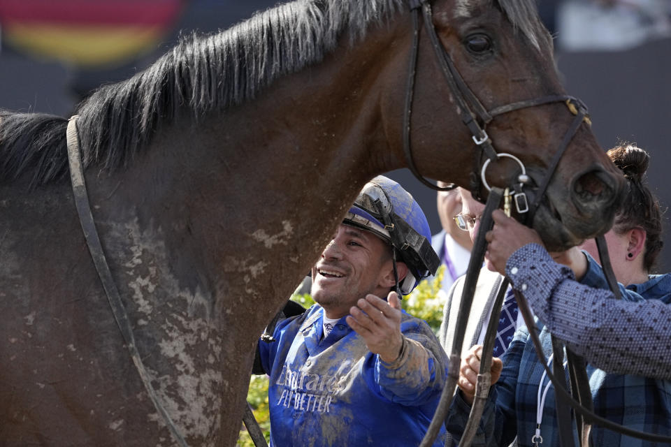 Junior Alvarado embraces Cody's Wish after winning the Breeders' Cup Dirt Mile horse race Saturday, Nov. 4, 2023, at Santa Anita Park in Arcadia, Calif. (AP Photo/Mark J. Terrill)