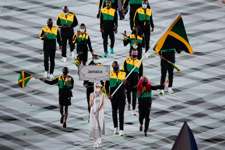 <p>TOKYO, JAPAN - JULY 23: Flag bearers Shelly-Ann Fraser-Pryce and Ricardo Brown of Team Jamaica take part in the Parade of Nations during the Opening Ceremony of the Tokyo 2020 Olympic Games at Olympic Stadium on July 23, 2021 in Tokyo, Japan. (Photo by Wei Zheng/CHINASPORTS/VCG via Getty Images)</p> 