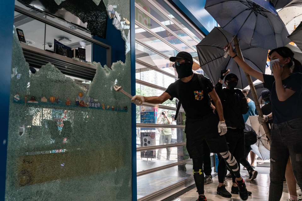 Pro-democracy protesters vandalize a China Mobile Ltd. store at Sheung Shui district on October 5, 2019 in Hong Kong, China. | Anthony Kwan—Getty Images