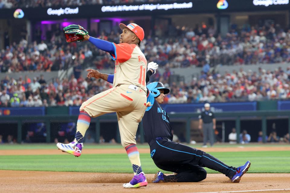 Shohei Ohtani of the Los Angeles Dodgers slides into third against Jose Ramirez of the Cleveland Guardians in the first inning of the MLB All-Star game, July 16, 2024, in Arlington, Texas.