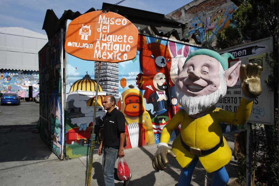 In this Jan. 11, 2017 photo, a man walks past the entrance to the Mexico Antique Toy Museum in Mexico City. The Mexico Antique Toy Museum is a four story building filled with toys and objects that bring back childhood memories to the visitors that enter this unique place. (AP Photo/Dario Lopez-Mills)