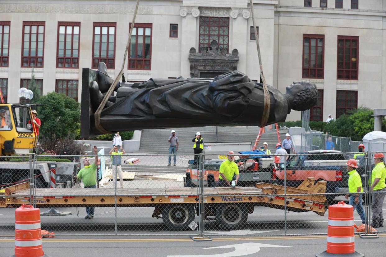 Workers place the Christopher Columbus statue onto a flatbed truck after removing it from its pedestal in front of Columbus City Hall in 2020.