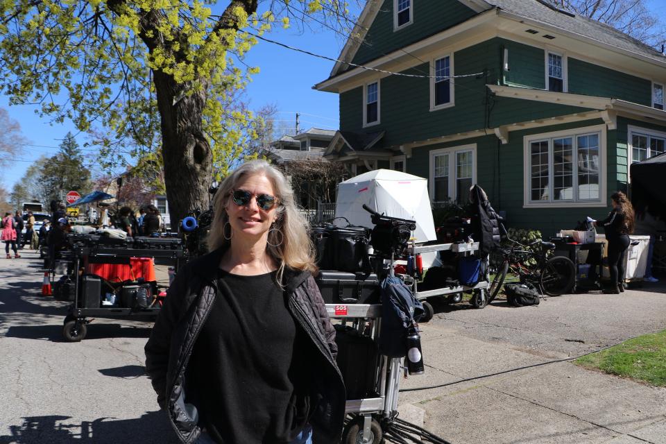 Lydia Breckon, who lives on Glenwood Avenue, Pawtucket, stands outside her home while the cast of "Ella McCay" films in her kitchen Monday afternoon.  [Paul Edward Parker/The Providence Journal]