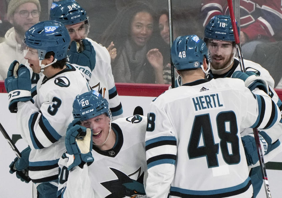 San Jose Sharks' Fabian Zetterlund (20) celebrates after his goal against the Montreal Canadiens with teammates Henry Thrun (3), Jan Rutta (84), Tomas Hertl (48) and Filip Zadina (18) during first-period NHL hockey game action in Montreal, Thursday, Jan. 11, 2024. (Christinne Muschi/The Canadian Press via AP)