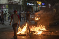 Angry demonstrators set fires, block the streets of the city center and clash with riot police following the death of Nizar Banat, an outspoken critic of the Palestinian Authority, in the West Bank city of Ramallah, Thursday, June 24, 2021. Banat who was a candidate in parliamentary elections called off earlier this year died after Palestinian security forces arrested him and beat him with batons on Thursday, his family said. (AP Photo/Nasser Nasser)