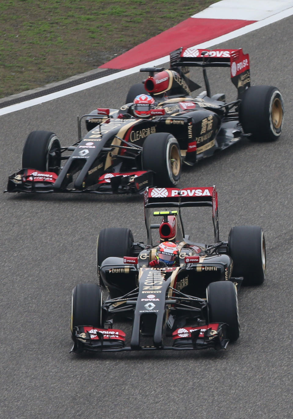 Lotus driver Romain Grosjean of France, top, and his teammate driver Pastor Maldonado of Venezuela, bottom, drive during the practice session for Sunday's Chinese Formula One Grand Prix at Shanghai International Circuit in Shanghai, Friday, April 18, 2014. (AP Photo/Eugene Hoshiko)