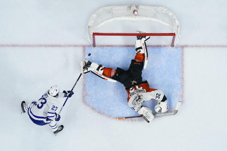 Toronto Maple Leafs' Matthew Knies, left, scores a goal against Philadelphia Flyers' Felix Sandstrom during the third period of an NHL hockey game, Thursday, March 14, 2024, in Philadelphia. (AP Photo/Matt Slocum)