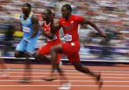 Justin Gatlin (R) of the U.S. runs on his way to winning in his men's 100m round 1 heat at the London 2012 Olympic Games at the Olympic Stadium August 4, 2012.