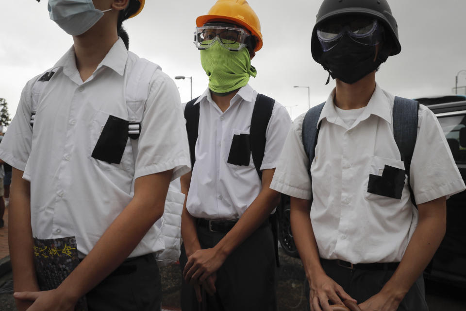 Secondary students wear helmets and facemasks during a protest in Hong Kong, on Monday, Sept. 2, 2019. Hong Kong has been the scene of tense anti-government protests for nearly three months. The demonstrations began in response to a proposed extradition law and have expanded to include other grievances and demands for democracy in the semiautonomous Chinese territory. (AP Photo/Kin Cheung)