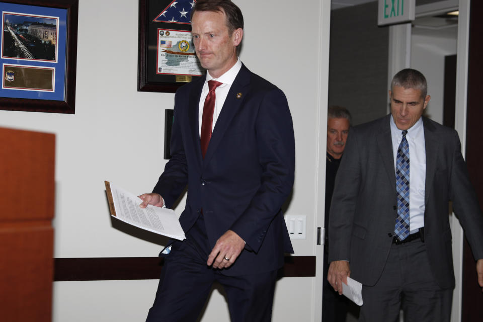 Jason R. Dunn, U.S. Attorney for the District of Colorado, front left, and Dean Phillips, FBI special agent in charge, front right, are joined by Chief Troy Davenport of the Pueblo, Colo., Police Department, to speak at a news conference in Denver Monday, Nov. 4, 2019, to announce the arrest of a man who repeatedly espoused anti-Semitic views in a plot to bomb a historic Colorado synagogue in Pueblo. Richard Holzer, 27, of Pueblo, was charged with a federal hate crime for plotting to blow up the Temple Emmanuel Synagogue in the southern Colorado city.(AP Photo/David Zalubowski)