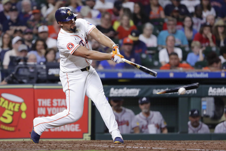 Houston Astros batter Jose Abreu breaks his bat as he connects against the Atlanta Braves during the seventh inning of a baseball game Monday, April 15, 2024, in Houston. (AP Photo/Michael Wyke)