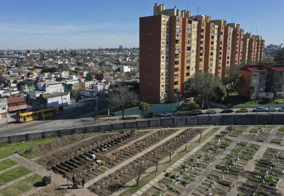 FILE - In this July 25, 2020 file photo, wooden crosses mark freshly dug graves at the Flores cemetery where people who died from the coronavirus are buried in Buenos Aires, Argentina. Argentina reached 1 million confirmed coronavirus cases on Monday, Oct. 19, 2020, according to the Ministry of Health. (AP Photo/Gustavo Garello, File)