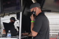 Cole Pearn looks at information on his computer screen for the Conor Daly car during a practice session for the Indianapolis 500 auto race at Indianapolis Motor Speedway, Thursday, Aug. 13, 2020, in Indianapolis. (AP Photo/Darron Cummings)