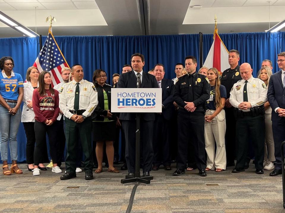 Gov. Ron DeSantis (center) speaks about the Hometown Heroes Housing Program.